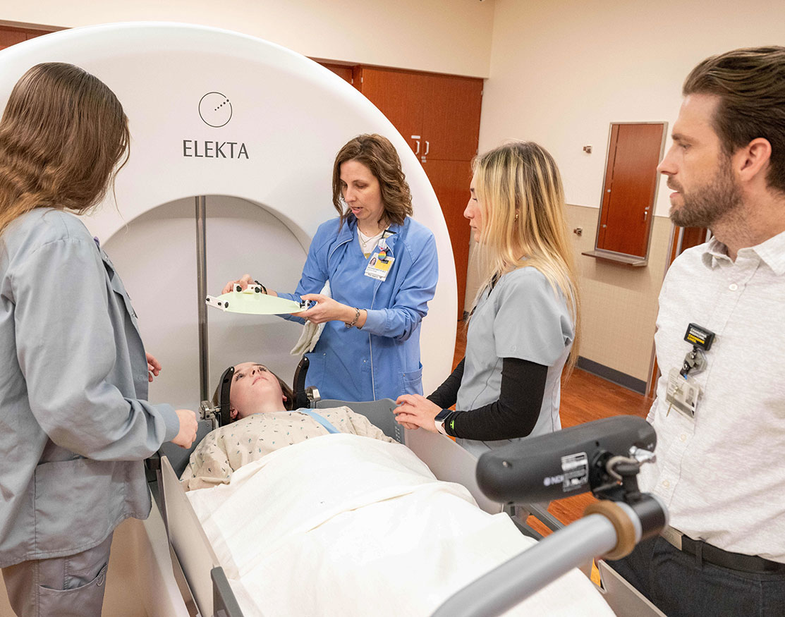 Tech instructor demonstrating radiation therapy imaging technique to students