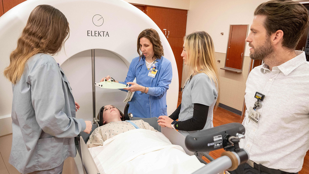 Rad therapy instructors showing students how to fit a mask for radiation therapy
