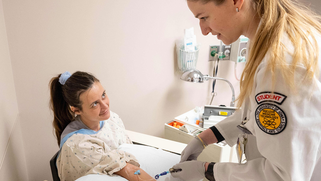 Nuclear Medicine technology student placing an IV line in another student